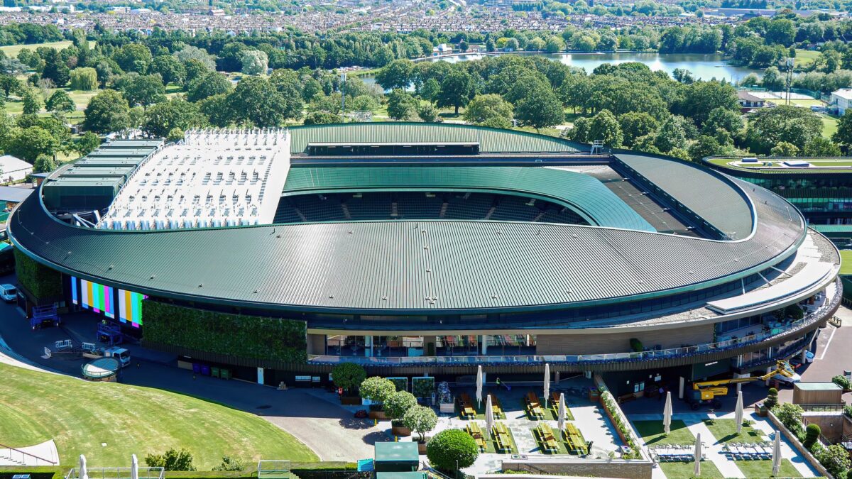 Arial shot of the iconic Wimbledon tennis stadium in the summer.